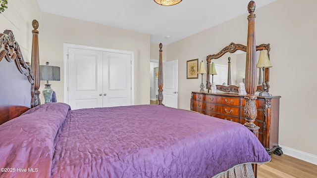 bedroom featuring baseboards, a closet, and wood finished floors