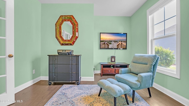 living area with baseboards, plenty of natural light, and dark wood finished floors