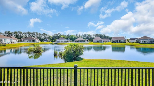 property view of water featuring a residential view and fence