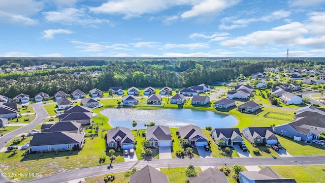 drone / aerial view with a water view and a residential view