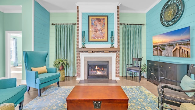 living area featuring crown molding, wooden walls, wood finished floors, and a fireplace