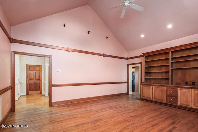 unfurnished living room with light wood-type flooring, high vaulted ceiling, and ceiling fan