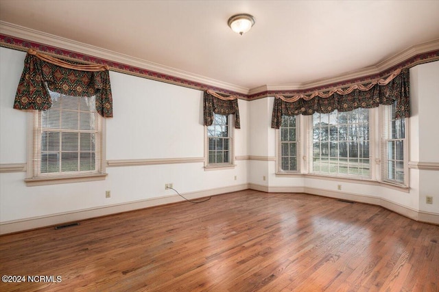 unfurnished room featuring crown molding and wood-type flooring