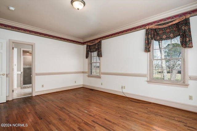 empty room featuring hardwood / wood-style floors and ornamental molding