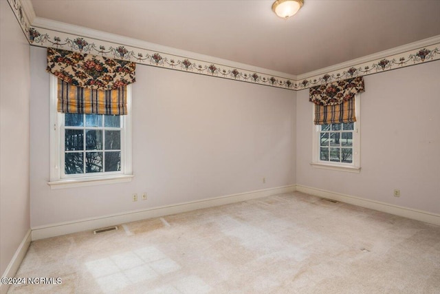 unfurnished room with carpet and crown molding