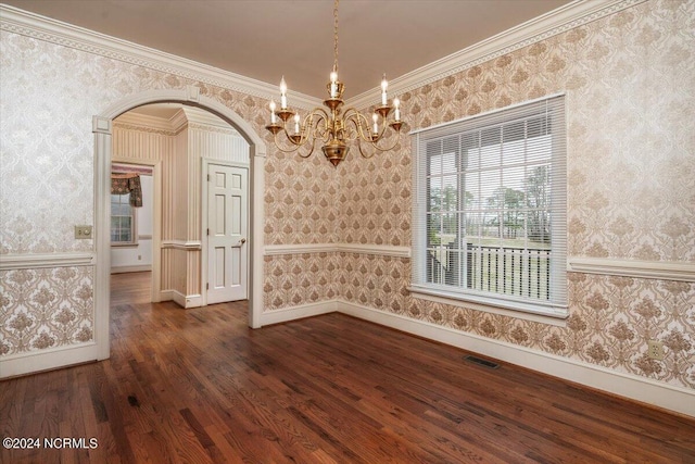 unfurnished dining area with dark hardwood / wood-style floors, an inviting chandelier, and crown molding