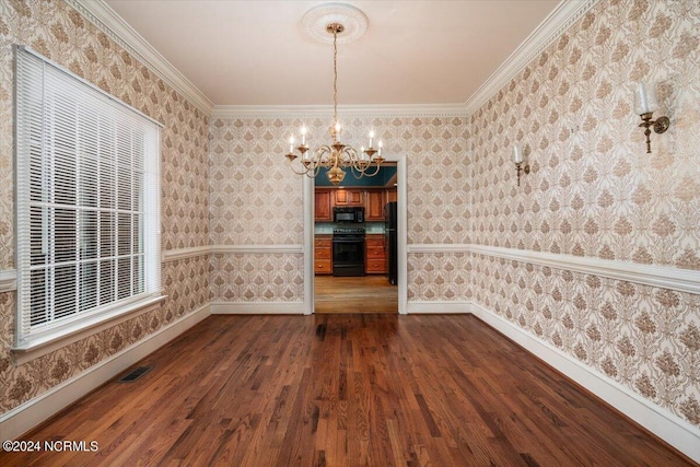 unfurnished dining area featuring a wealth of natural light, dark hardwood / wood-style flooring, a chandelier, and ornamental molding