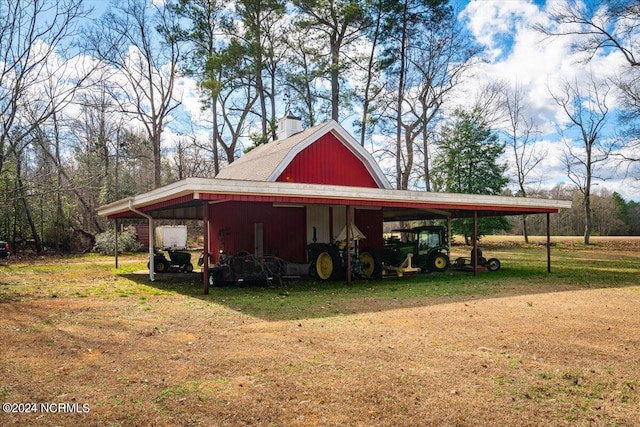 view of outbuilding featuring a lawn