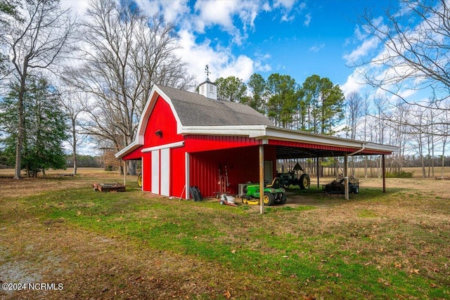 view of outbuilding with a carport and a lawn