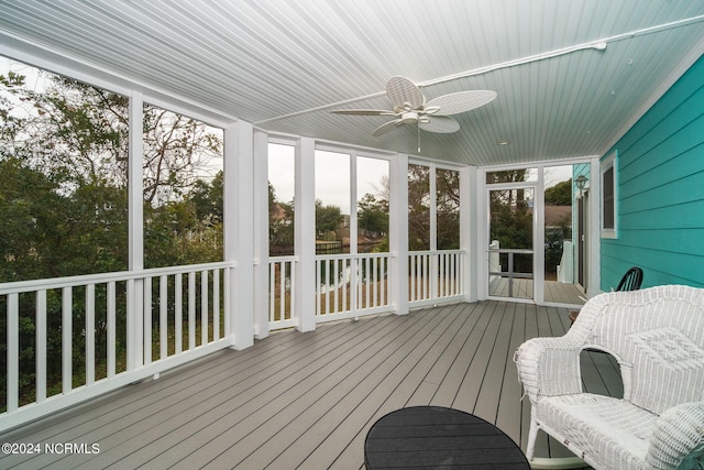 sunroom featuring ceiling fan and a healthy amount of sunlight