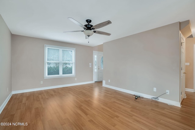 unfurnished room with ceiling fan and light wood-type flooring