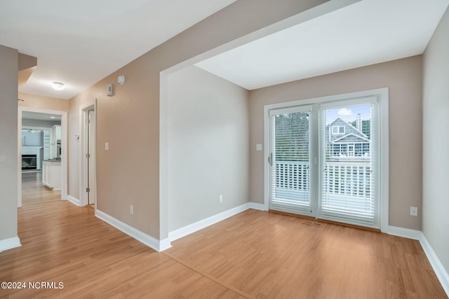 unfurnished room with light hardwood / wood-style floors