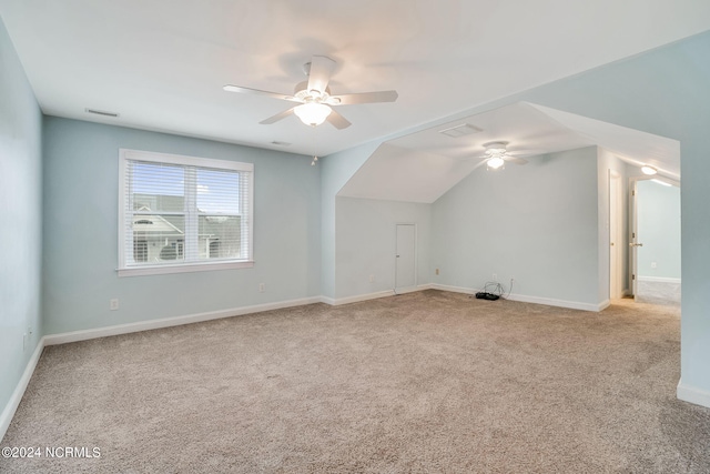 additional living space featuring ceiling fan, light carpet, and vaulted ceiling