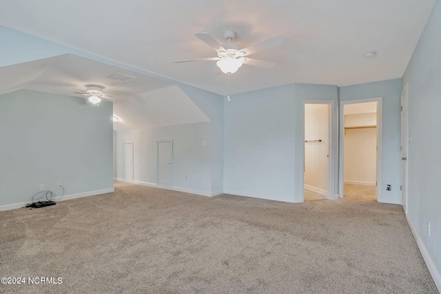 interior space featuring light carpet, lofted ceiling, and ceiling fan