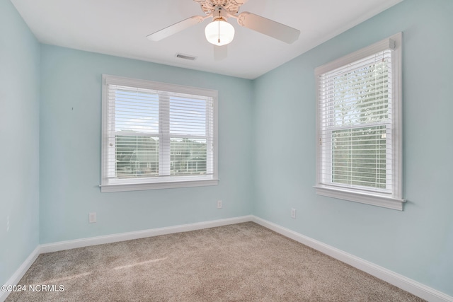 unfurnished room with ceiling fan and light colored carpet