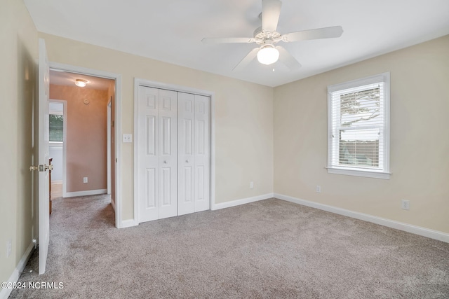 unfurnished bedroom featuring a closet, ceiling fan, and light colored carpet