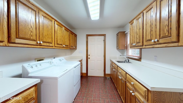 washroom featuring washer and clothes dryer, cabinets, sink, and hookup for a washing machine