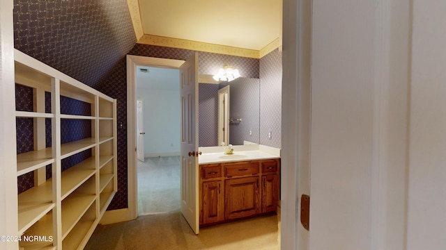 bathroom with large vanity and vaulted ceiling