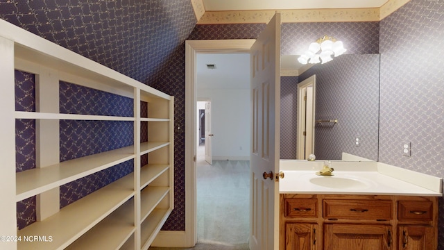 bathroom featuring vanity and a chandelier