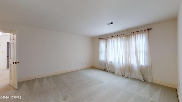 empty room featuring light colored carpet