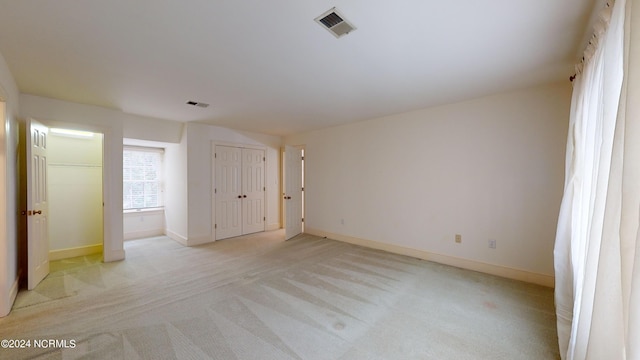 unfurnished bedroom featuring light carpet