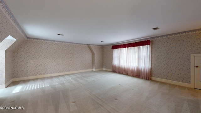 spare room featuring light colored carpet