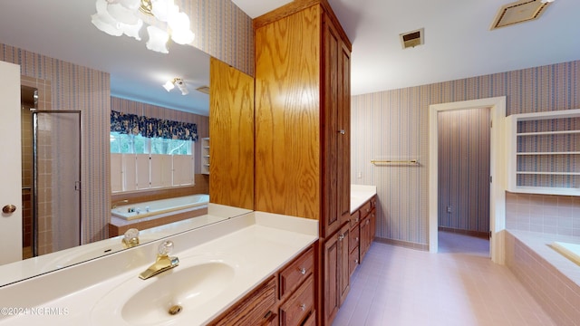 bathroom featuring vanity and tiled bath