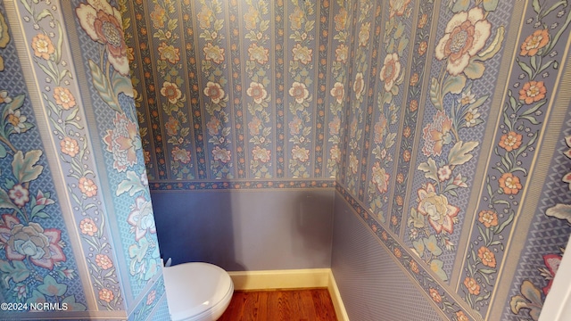 bathroom with toilet and hardwood / wood-style flooring