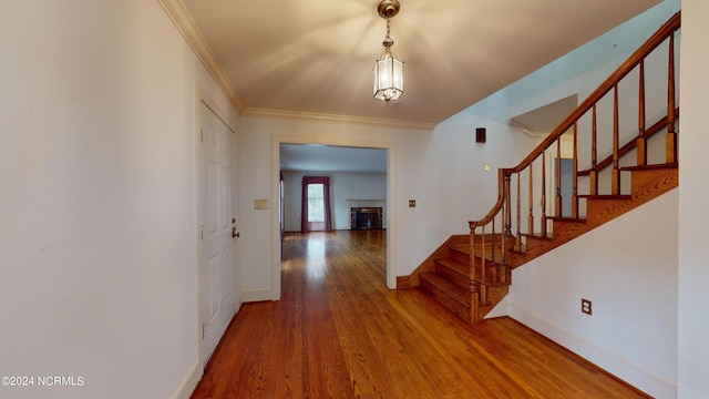 interior space featuring crown molding and light wood-type flooring