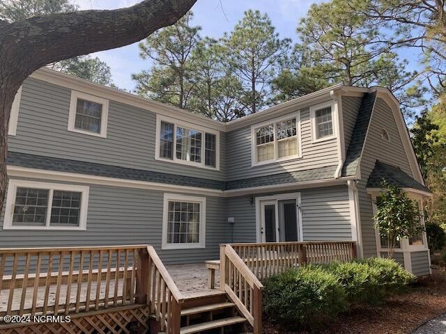 back of property featuring a wooden deck