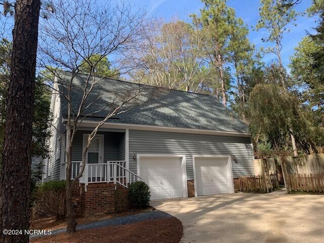 view of front of property with a porch and a garage