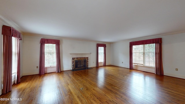 unfurnished living room with crown molding and dark wood-type flooring