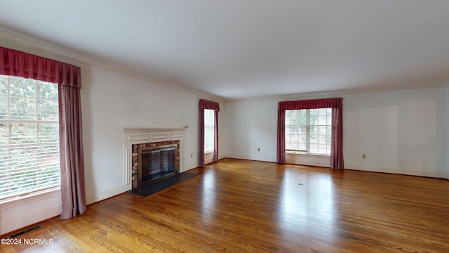 unfurnished living room featuring crown molding and hardwood / wood-style flooring