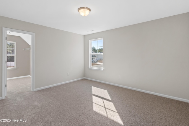 spare room featuring light carpet