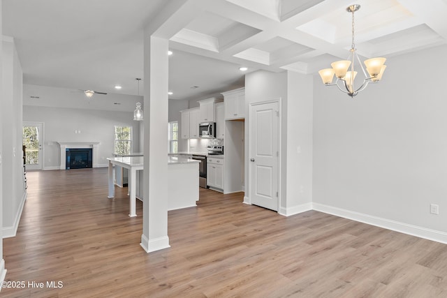 kitchen featuring appliances with stainless steel finishes, a center island, white cabinets, and a kitchen breakfast bar