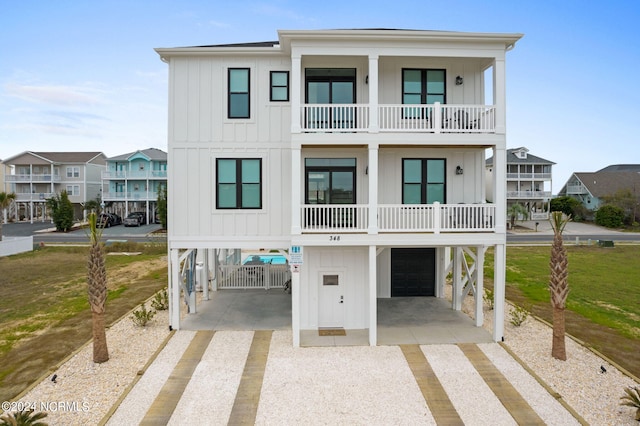 view of front of home with a balcony, a front yard, and a garage