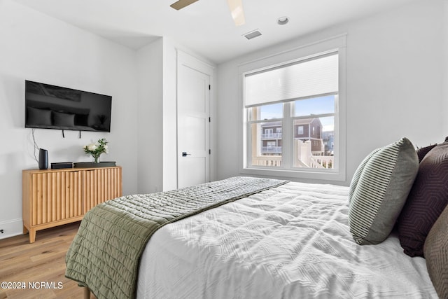 bedroom with ceiling fan and light hardwood / wood-style flooring