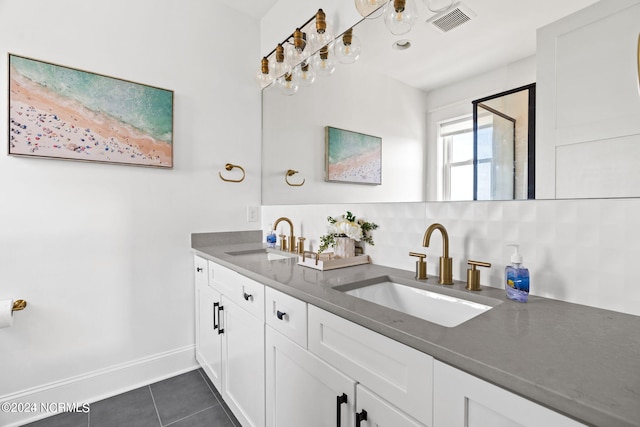 bathroom featuring tile flooring, backsplash, large vanity, and dual sinks