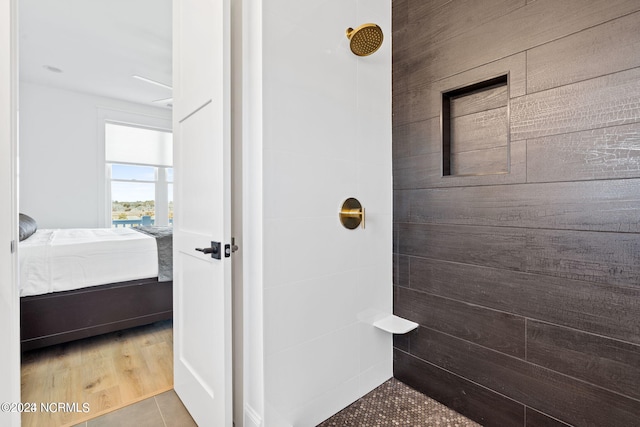 bathroom featuring tiled shower and hardwood / wood-style floors