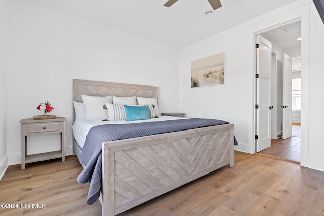 bedroom with ceiling fan and light wood-type flooring