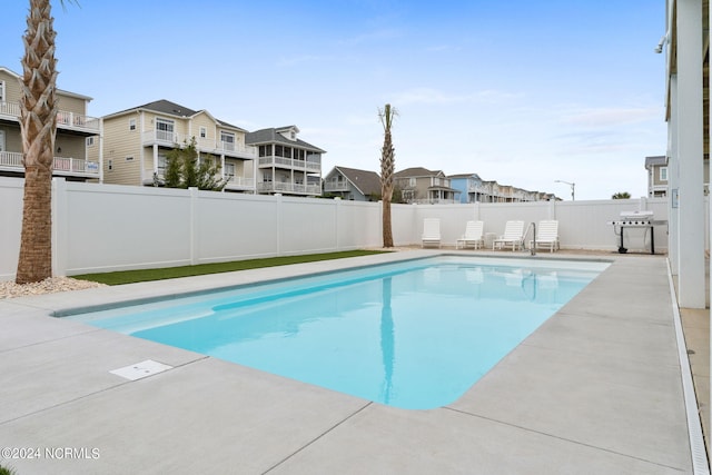 view of pool featuring a grill