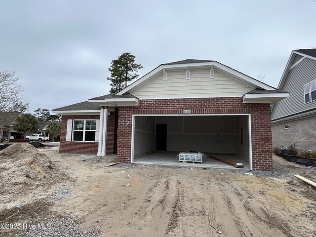 view of front of property with a front yard and a garage