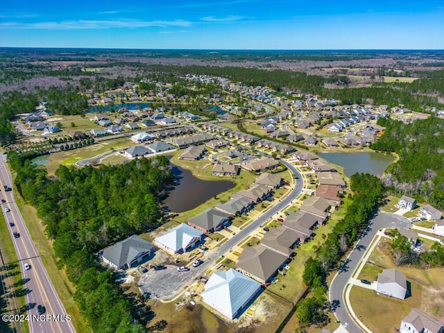 birds eye view of property with a water view and a residential view