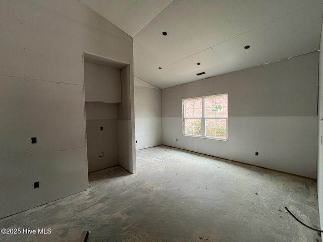 unfurnished room with lofted ceiling and visible vents