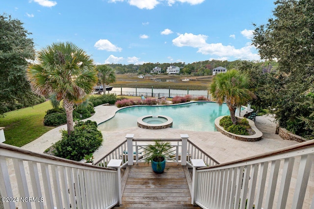 view of swimming pool with a patio area and an in ground hot tub