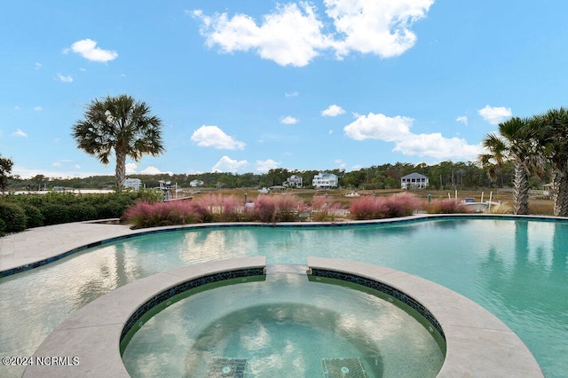 view of swimming pool featuring an in ground hot tub