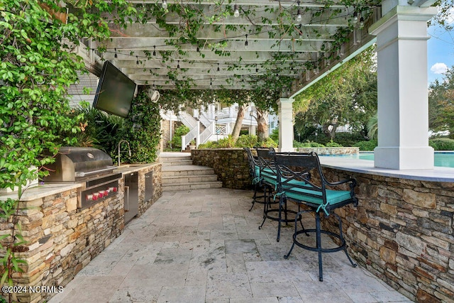 view of patio / terrace featuring a grill and exterior kitchen