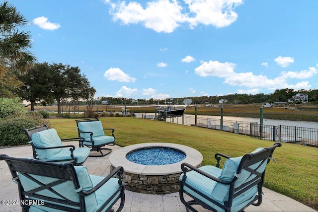 view of patio with an outdoor fire pit and a water view