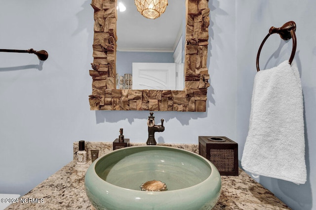 bathroom featuring crown molding and sink