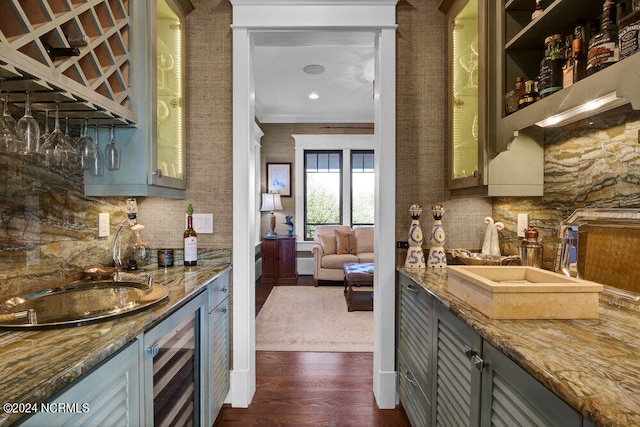 kitchen with stone counters, beverage cooler, tasteful backsplash, dark hardwood / wood-style flooring, and ornamental molding